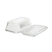 Mantequillera de vidrio transparente con base y tapa acanalada desmontadas.